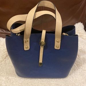 Navy blue leather pocket book with detachable zip clutch inside.